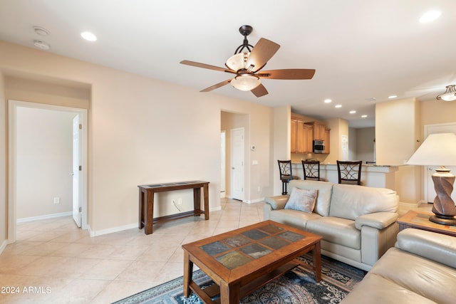 living room with ceiling fan and light tile patterned floors