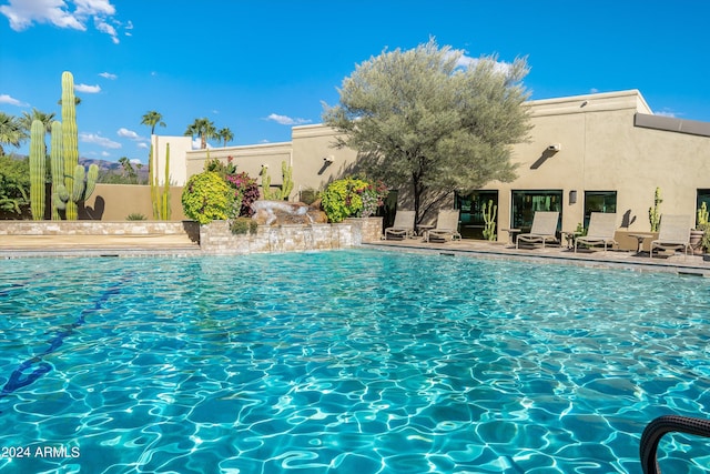 view of swimming pool with a patio area and pool water feature