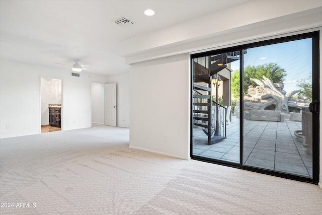 spare room featuring ceiling fan and light colored carpet