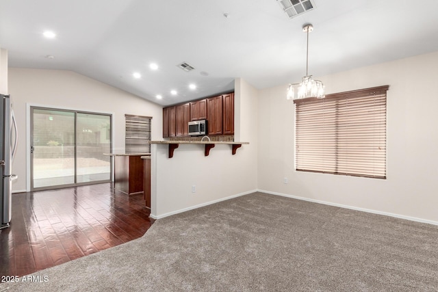 12838 W Desert Mirage Dr, Peoria, AZ 85383 - kitchen with visible vents, a chandelier, a kitchen bar, and stainless steel appliances