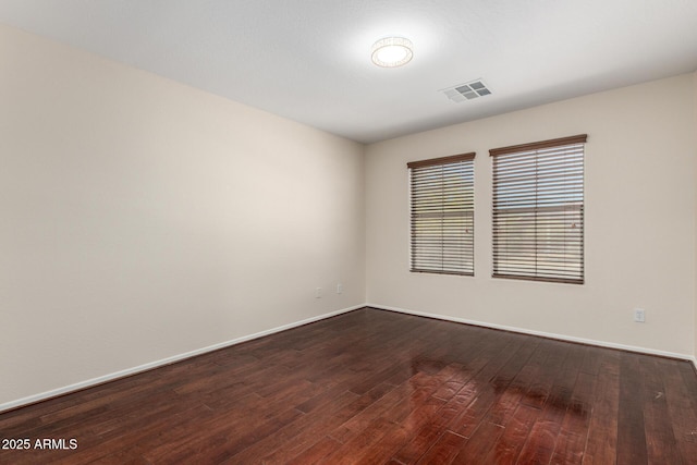 12838 W Desert Mirage Dr, Peoria, AZ 85383 - unfurnished room featuring baseboards, dark wood finished floors, and visible vents