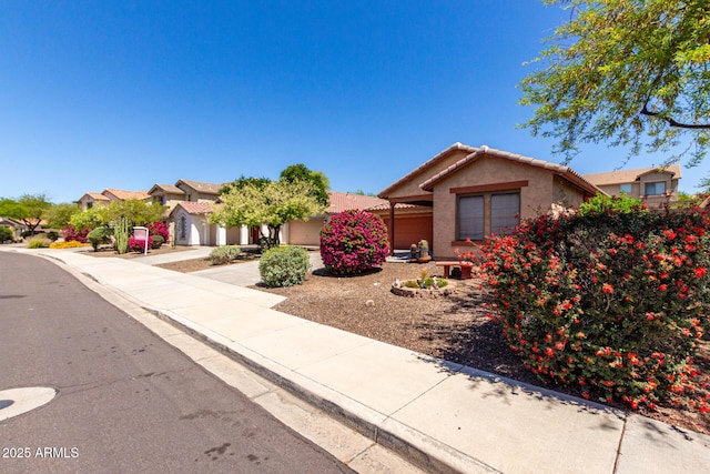 12838 W Desert Mirage Dr, Peoria, AZ 85383 - view of front of house featuring a tiled roof, a residential view, a garage, concrete driveway, and stucco siding