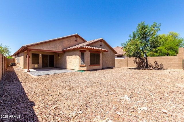 12838 W Desert Mirage Dr, Peoria, AZ 85383 - rear view of property featuring a tiled roof, a fenced backyard, a patio area, and stucco siding