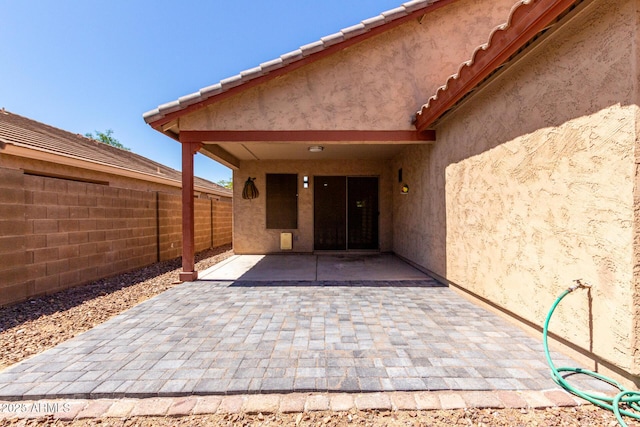 12838 W Desert Mirage Dr, Peoria, AZ 85383 - doorway to property with a patio, fence, and stucco siding