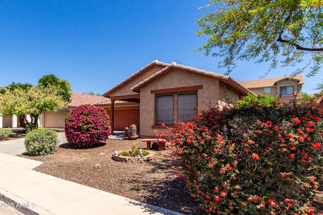 12838 W Desert Mirage Dr, Peoria, AZ 85383 - view of front of house with an attached garage, a tile roof, and stucco siding