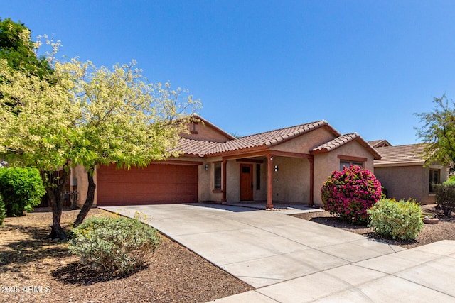 12838 W Desert Mirage Dr, Peoria, AZ 85383 - view of front of property featuring a garage, stucco siding, a tiled roof, and concrete driveway