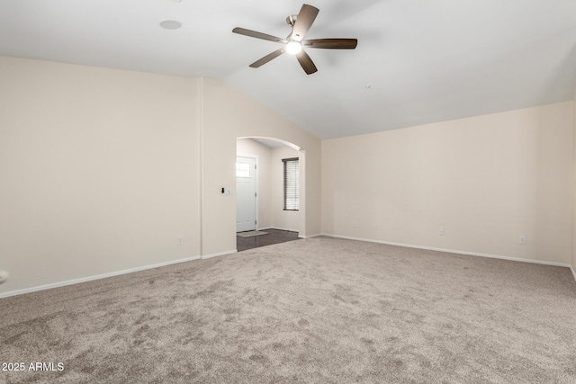 12838 W Desert Mirage Dr, Peoria, AZ 85383 - carpeted empty room featuring baseboards, arched walkways, a ceiling fan, and vaulted ceiling