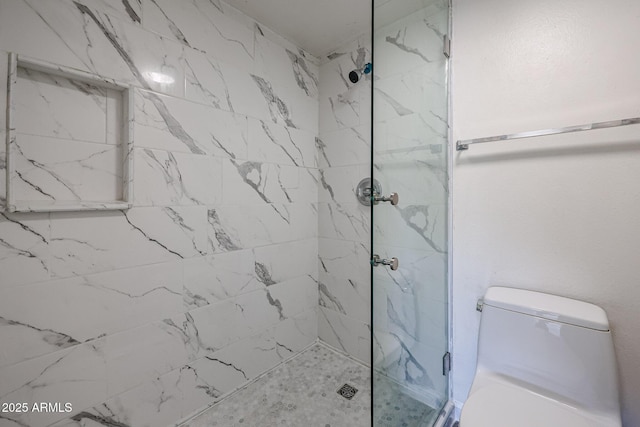 bathroom with tiled shower and toilet