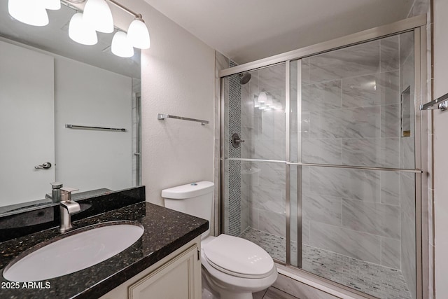 bathroom with vanity, walk in shower, and toilet