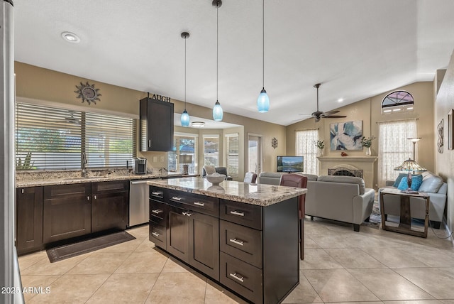 kitchen featuring vaulted ceiling, dark brown cabinetry, dishwasher, and hanging light fixtures