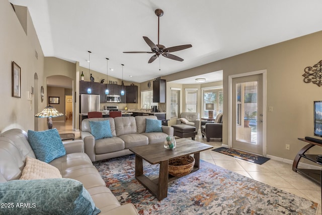 tiled living room featuring lofted ceiling and ceiling fan