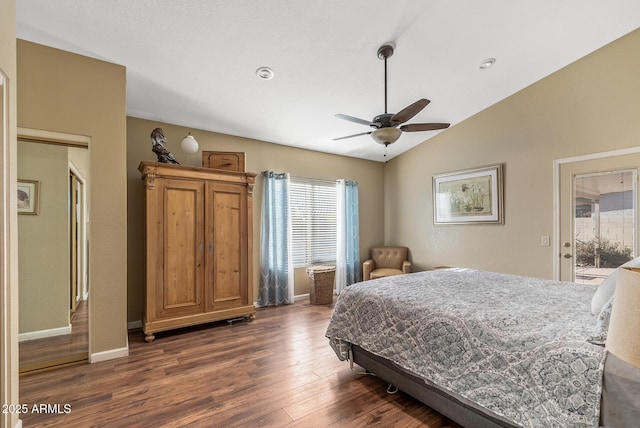 bedroom with vaulted ceiling, ceiling fan, dark hardwood / wood-style floors, and access to outside