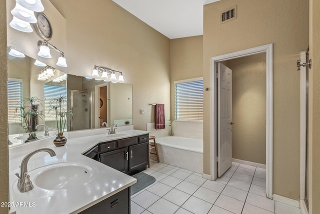 bathroom with tile patterned flooring, separate shower and tub, and vanity