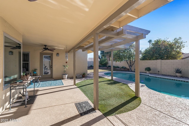 view of pool with ceiling fan, a lawn, and a patio