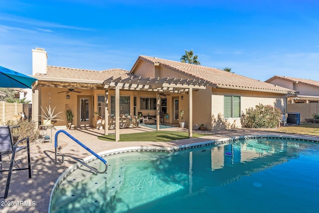 back of property with a pergola, ceiling fan, a patio area, a fenced in pool, and central air condition unit