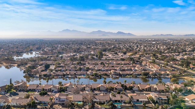 drone / aerial view with a water and mountain view