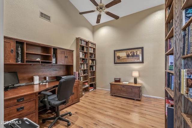 office with vaulted ceiling, ceiling fan, and light hardwood / wood-style flooring