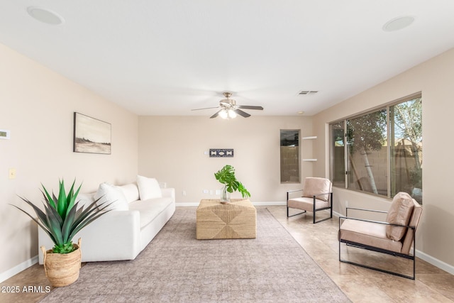 living room featuring visible vents, a ceiling fan, and baseboards