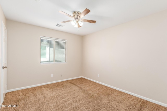 spare room with visible vents, baseboards, carpet, and a ceiling fan