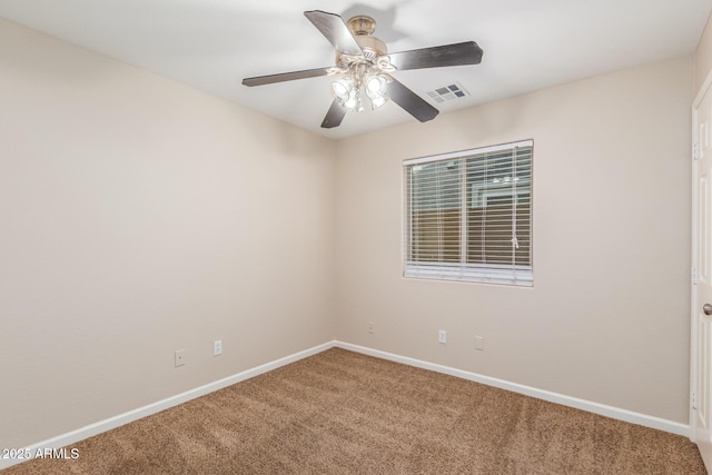 unfurnished room with visible vents, baseboards, carpet, and a ceiling fan