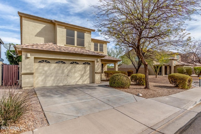 view of front of home featuring stucco siding, a garage, concrete driveway, and fence