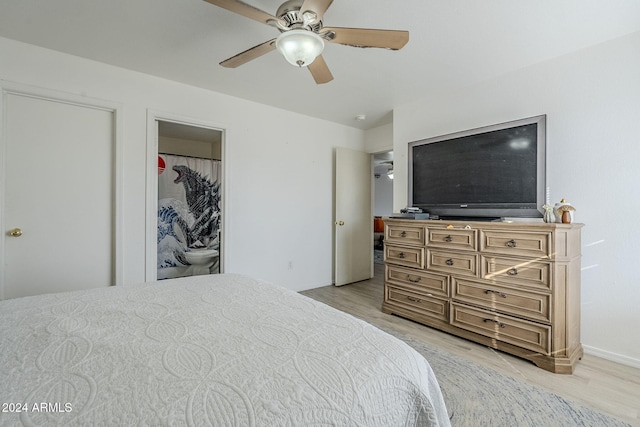 bedroom featuring ensuite bathroom, light hardwood / wood-style flooring, and ceiling fan