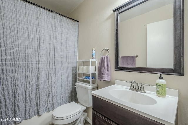 full bathroom featuring vanity, shower / bath combo, and toilet