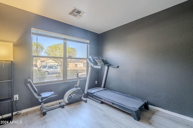 workout room with wood-type flooring