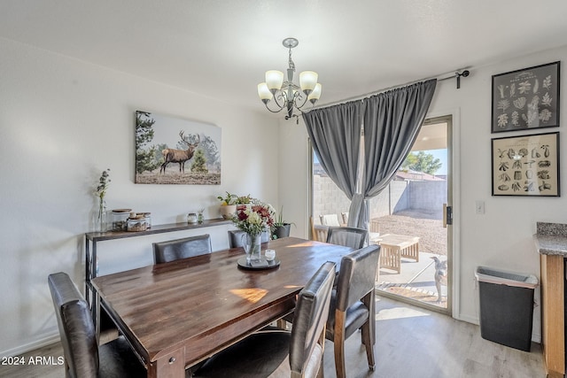 dining area featuring a chandelier and light wood-type flooring