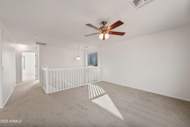 empty room featuring light carpet and ceiling fan