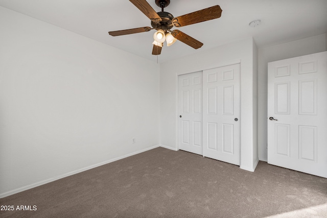 unfurnished bedroom with ceiling fan, a closet, and dark colored carpet