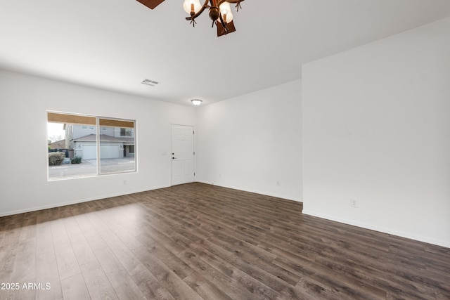 spare room featuring dark wood-type flooring