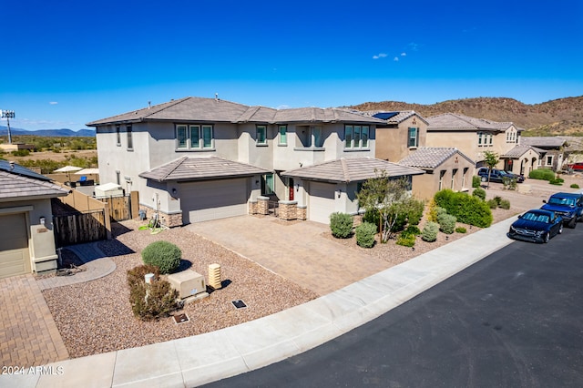 view of front of home with a mountain view and a garage