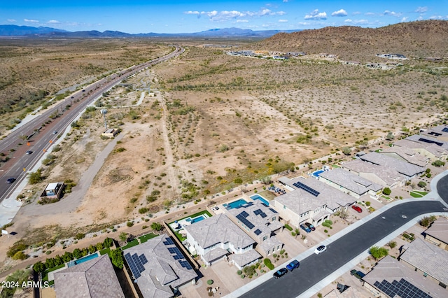 birds eye view of property with a mountain view