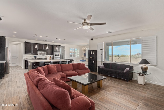 living room with ceiling fan and hardwood / wood-style flooring