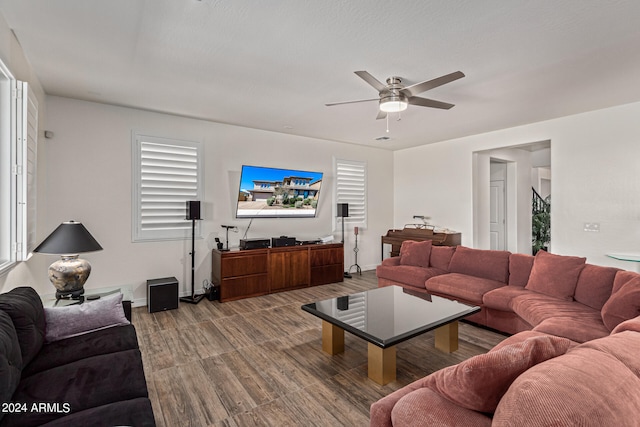 living room with wood-type flooring and ceiling fan