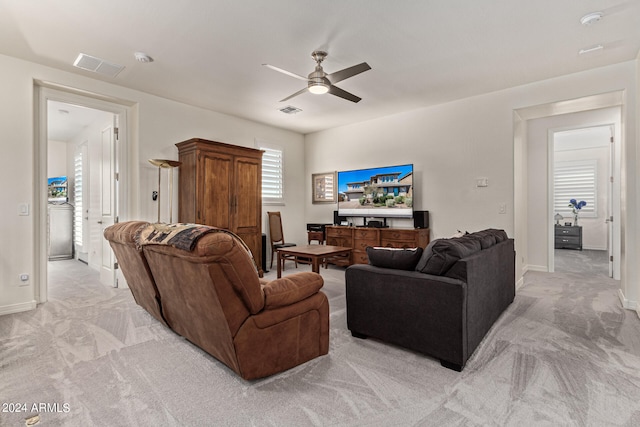 living room featuring ceiling fan and light colored carpet