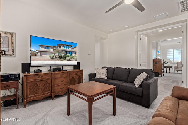 living room with light carpet and ceiling fan