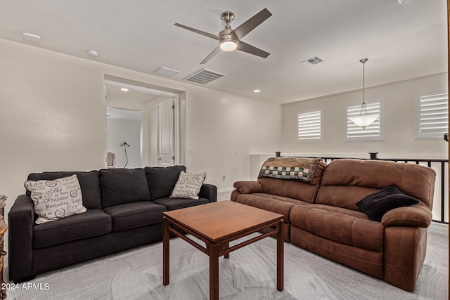 living room with ceiling fan and light colored carpet