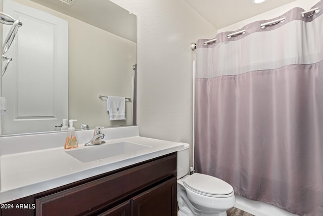 bathroom with a shower with curtain, vanity, and toilet