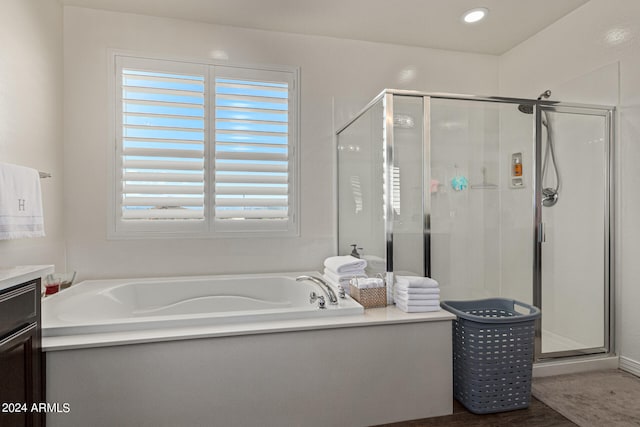 bathroom with wood-type flooring, vanity, and separate shower and tub