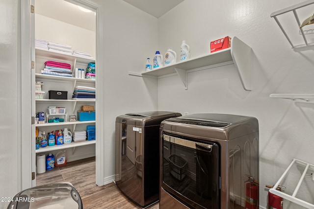 clothes washing area featuring hardwood / wood-style flooring and independent washer and dryer