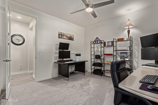 carpeted office featuring ceiling fan