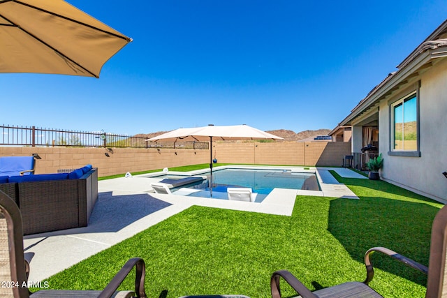 view of swimming pool featuring a yard and a patio area