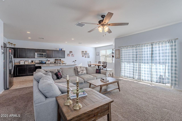 carpeted living room featuring ceiling fan