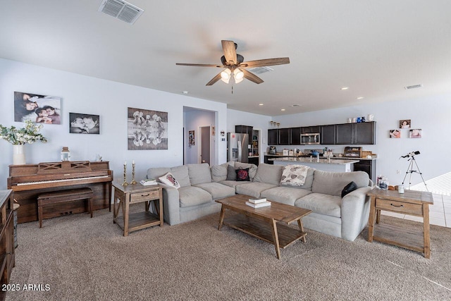 living room featuring light carpet and ceiling fan