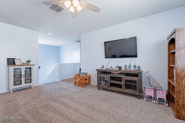 living room featuring carpet floors and ceiling fan