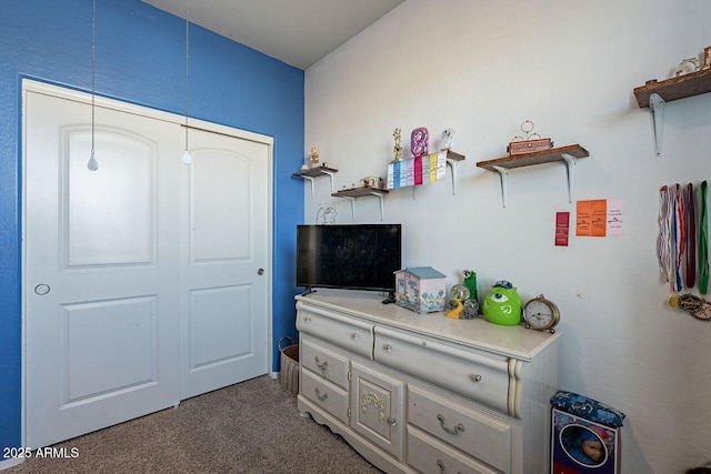 bedroom featuring dark colored carpet and a closet