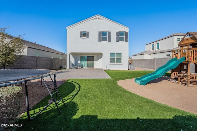 back of house with a patio area, a playground, central AC, a lawn, and a trampoline