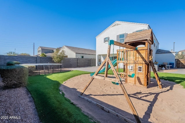 view of playground featuring a lawn and a trampoline